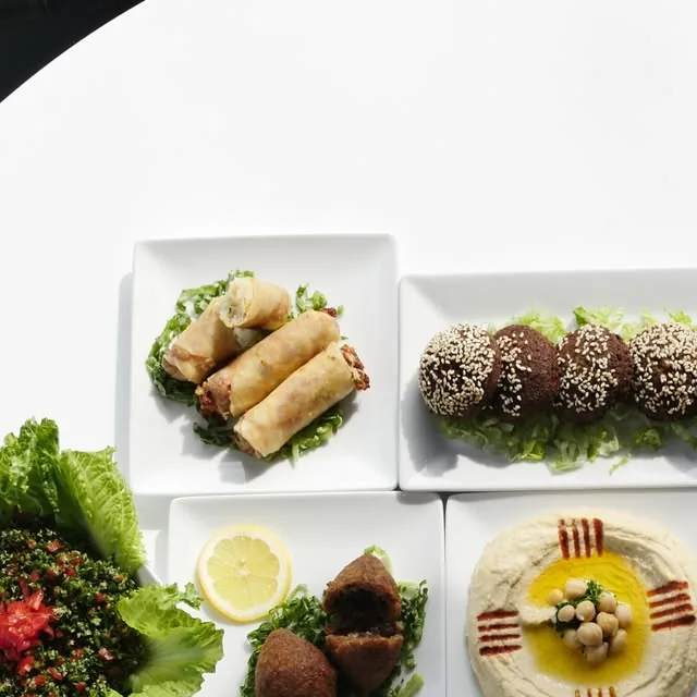 Mediterranean mezze spread with cheese rolls, falafel, tabbouleh and hummus at Mezze Cafe Austin