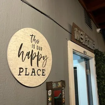 'This is our happy place' sign at the Mezze Cafe entrance in Austin
