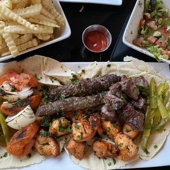 Mixed grill platter with kafta, chicken, fries and grilled vegetables at Mezze Cafe Austin