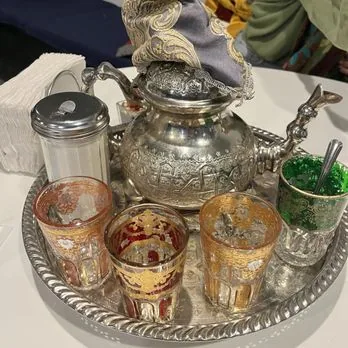 Ornate silver teapot with colored tea glasses at Mezze Cafe Austin