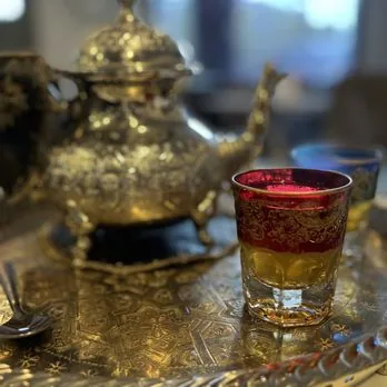 Golden teapot with a red tea glass at Mezze Cafe Austin